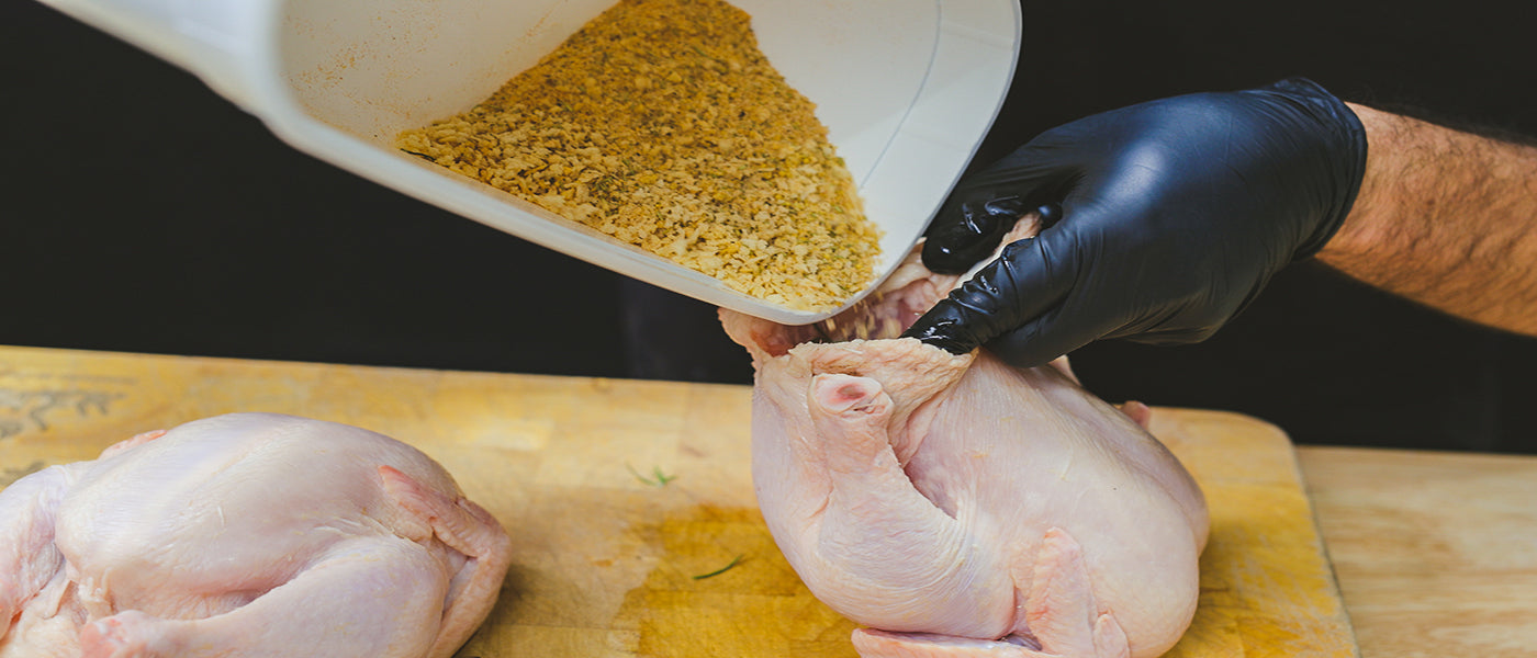 This image shows a whole chicken stuff with Flaming coals rub