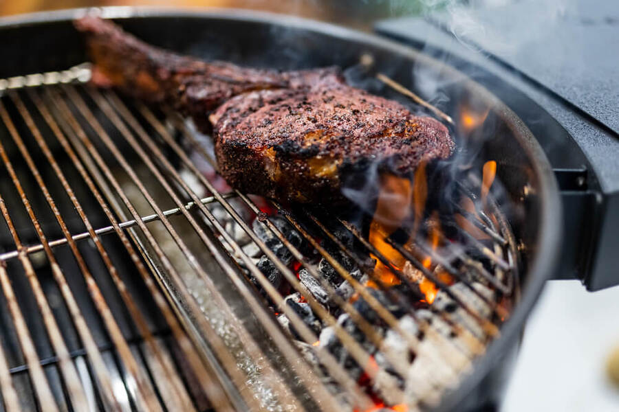 This_image_shows_tomahawak_steak_being_cooked_on_direct_heat