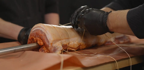 Placing the pork belly into the skewer