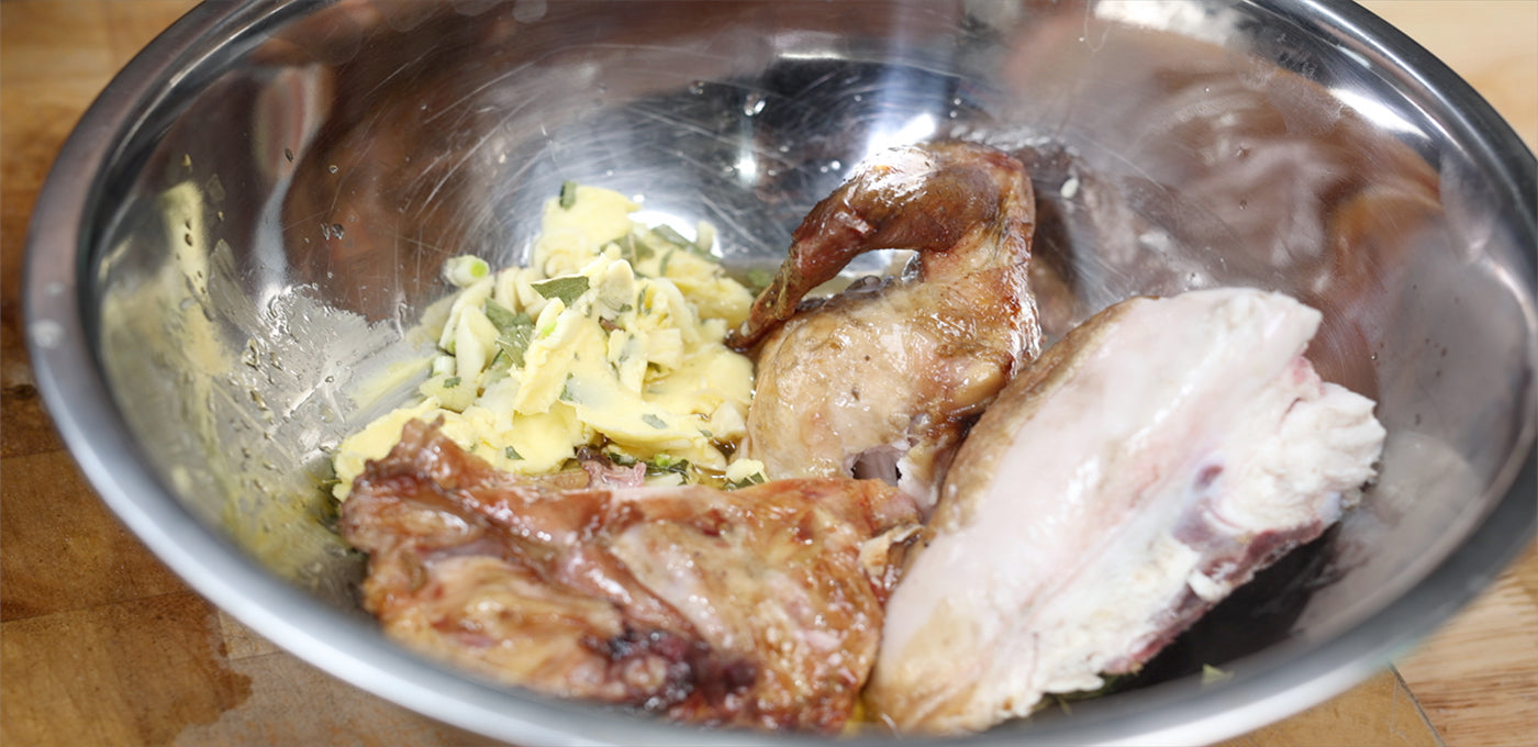 This image shows a chicken in a bowl with seasoning