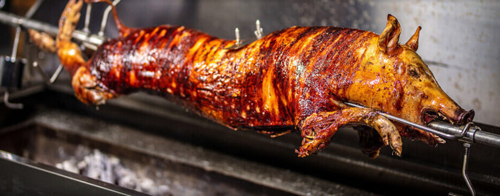 This image shows a Whole Pig on a Spit Rotisserie
