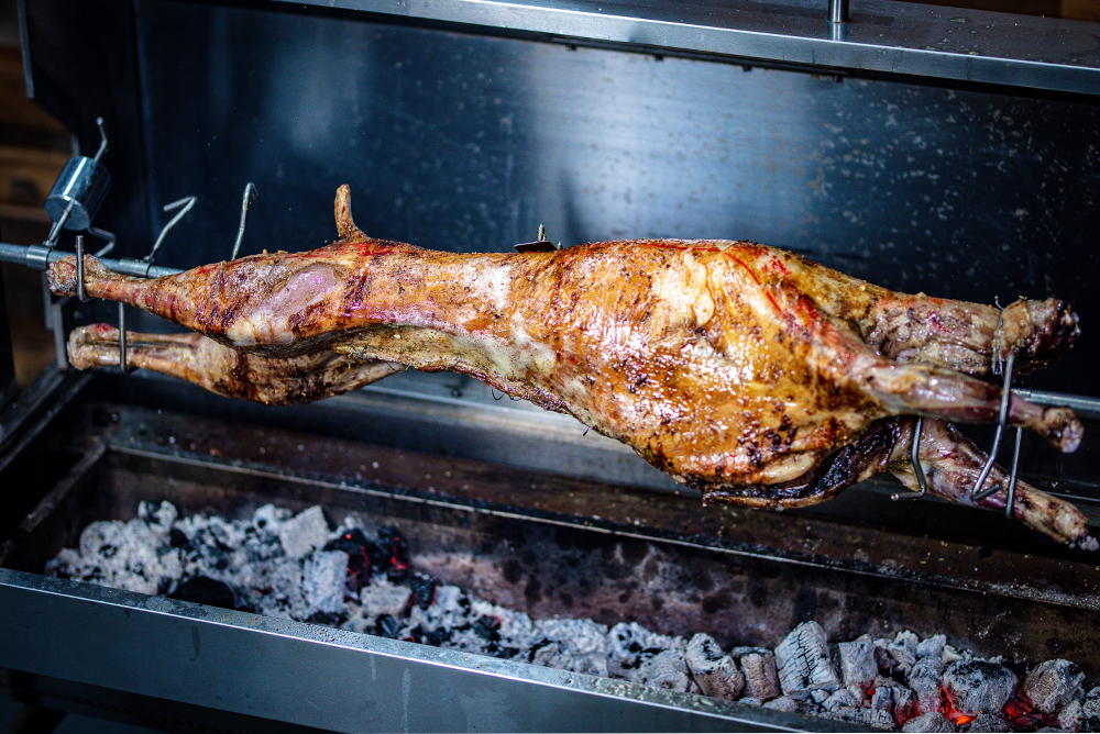 This_image_shows_whole_lamb_on_the_spit_roaster