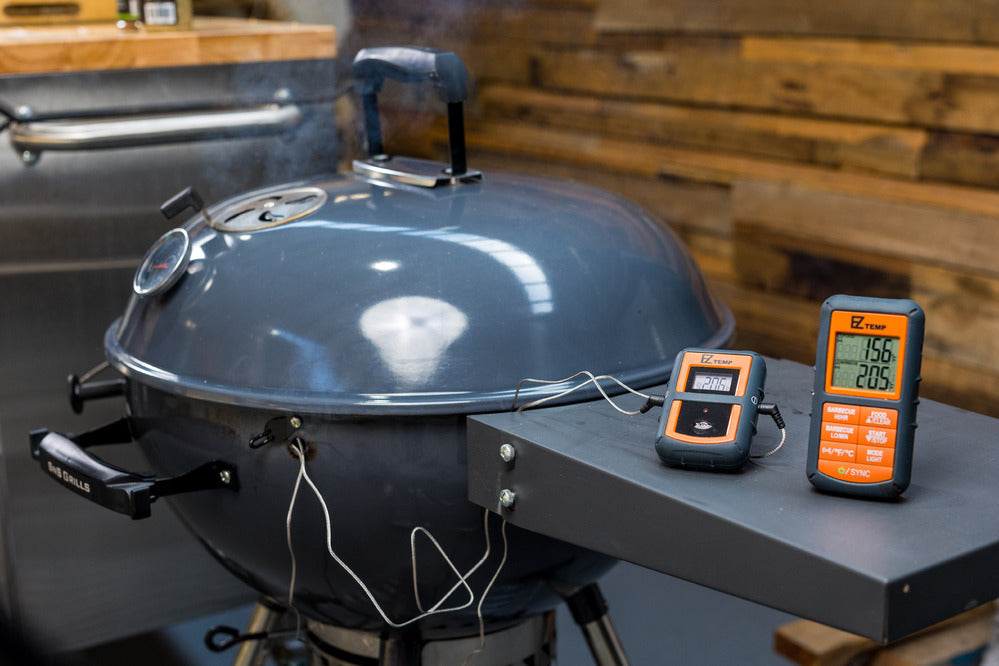 This image shows the EZtemp wireless remote smoker gauge monitoring the coking and food temperatures in a kettle BBQ