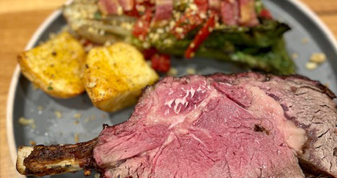 This image shows a beef rib roast with lettuce and pickled red peppers