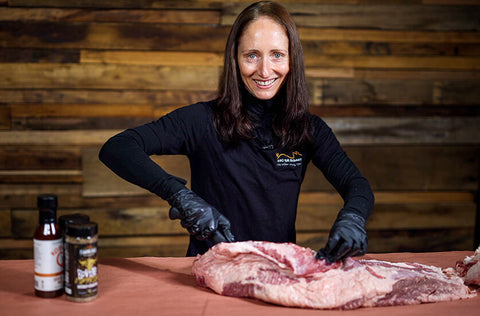 This image shows the excess fat of the lamb being trimmed.