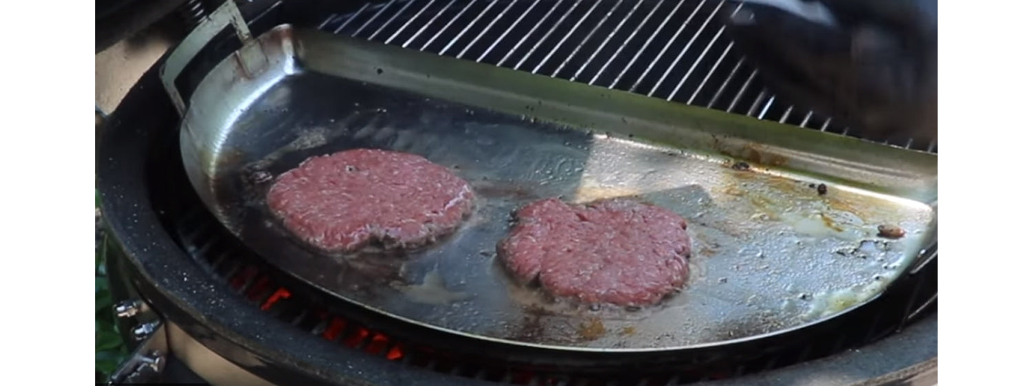 This image shows burger patties on kamado grill