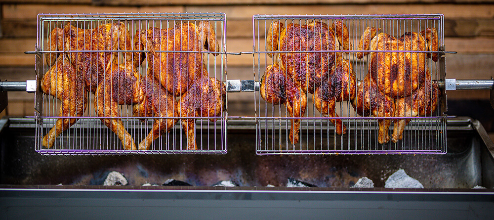 This image shows butterflied chicken cooked in a Jumbuck mini spit roaster
