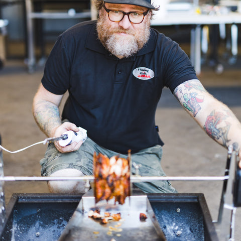 This image shows Cameron Davidson cooking butterflied chicken and gyros on Jumbuck mini Spit. The image was taken just after the skewer fell out of the motor. 