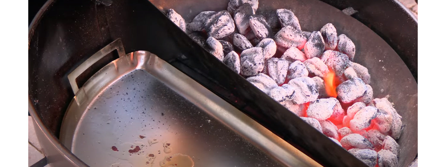This image shows lit charcoal on SNS kettle grill