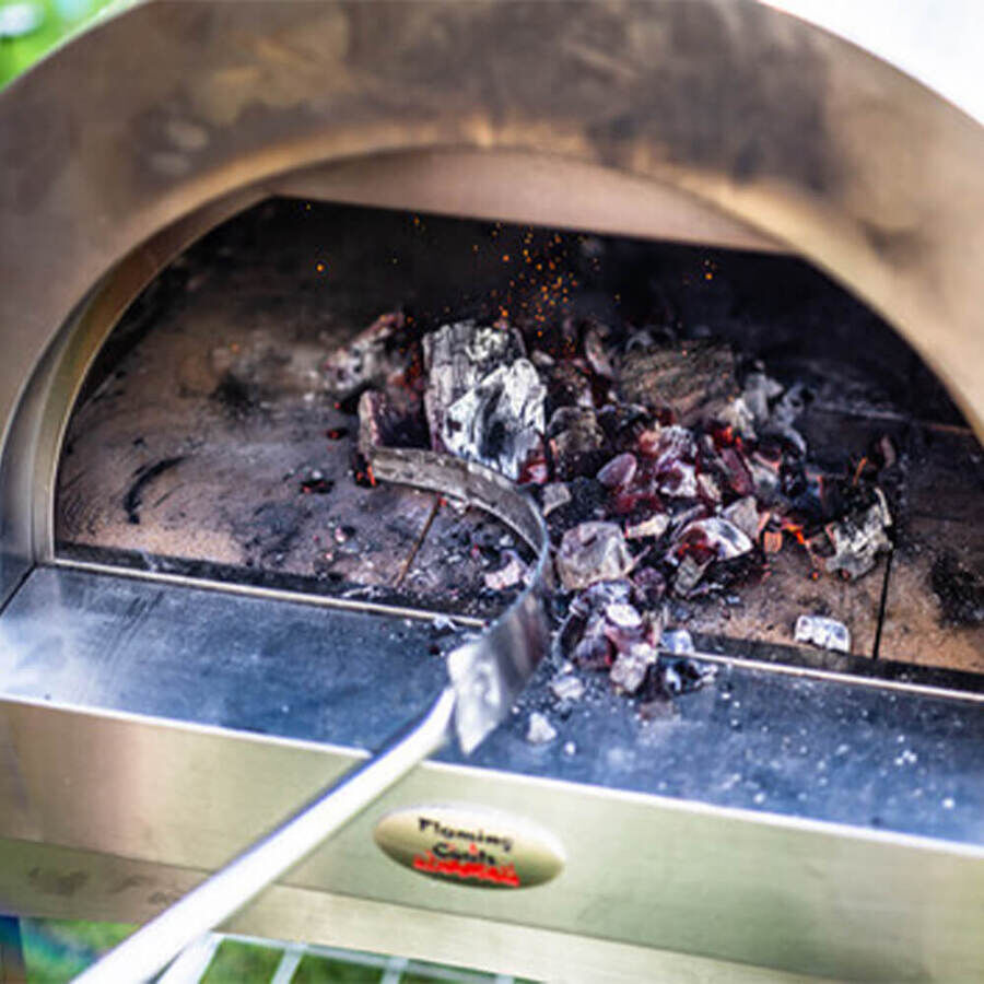 This_image_shows_cleaning_ashes_in_wood_fired_pizza_oven