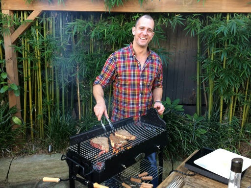 This image show a famous celebrity using his Cyprus grill to cook steaks