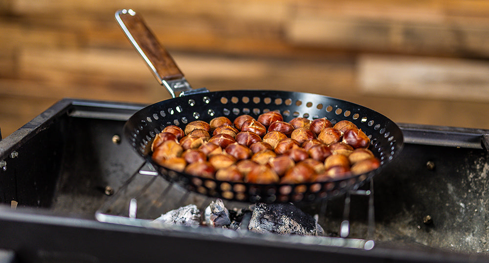 This image shows chestnuts being cooked using the cast iron skillet This image shows chestnuts being cooked using the cast iron skillet