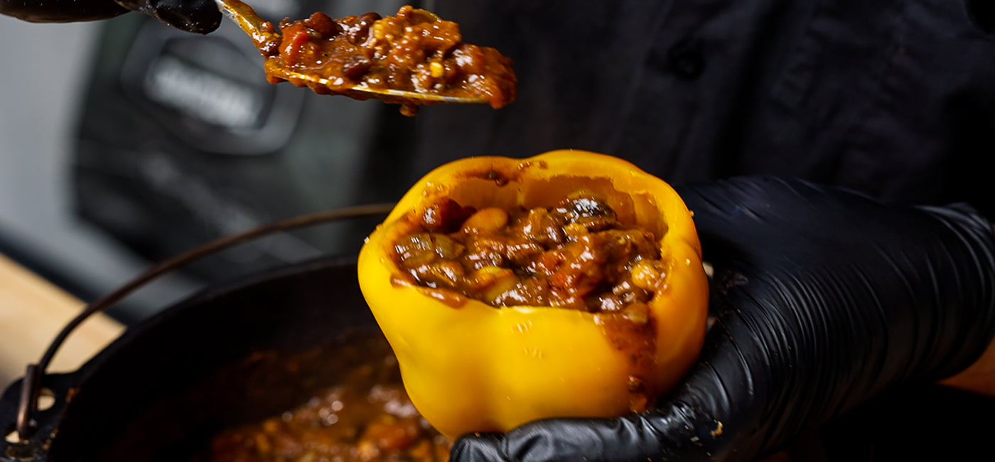 This images shows a man begin stuffing this chili into the capsciums