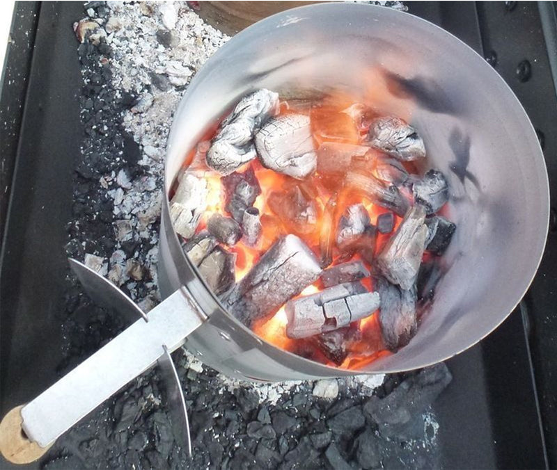 This image shows charcoal placed under the lit charcoal