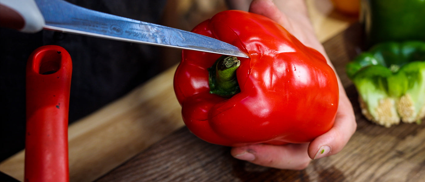 This image shows a capsicum is being cut on top 