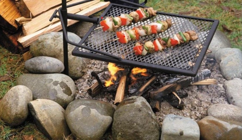 This image shows a cook on a Portable Swinging Camping Grill