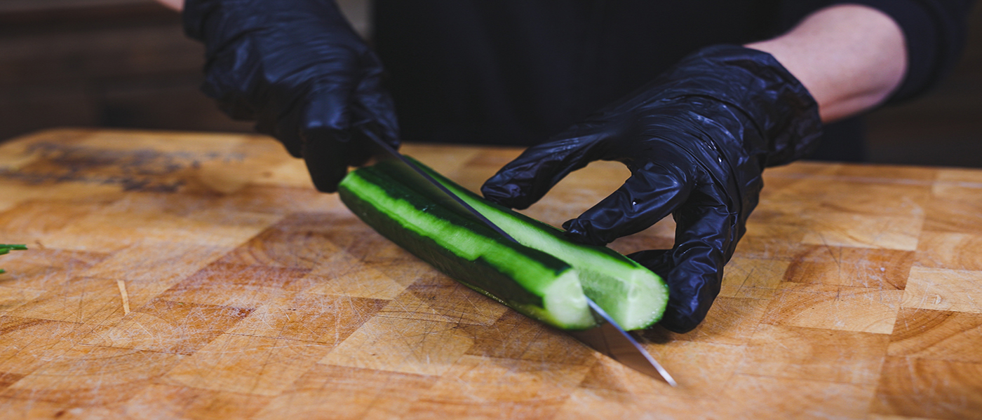 This image shows a man peeling the cucmber