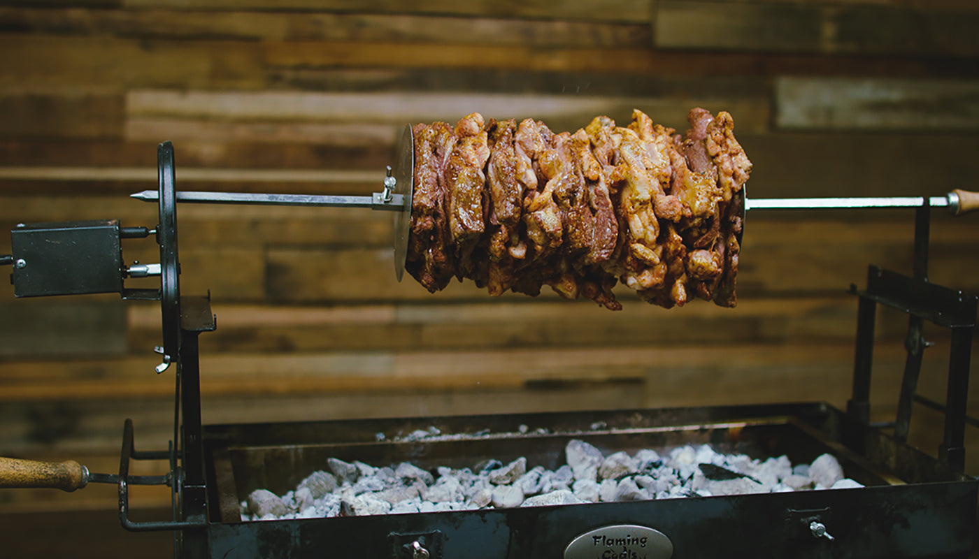 This image shows the chicken and lamb shoulder spining on the cyprus spit