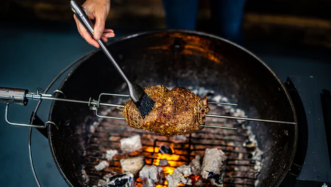 This_image_shows_Lamb_shoulder_being_basted_with_olive_oil