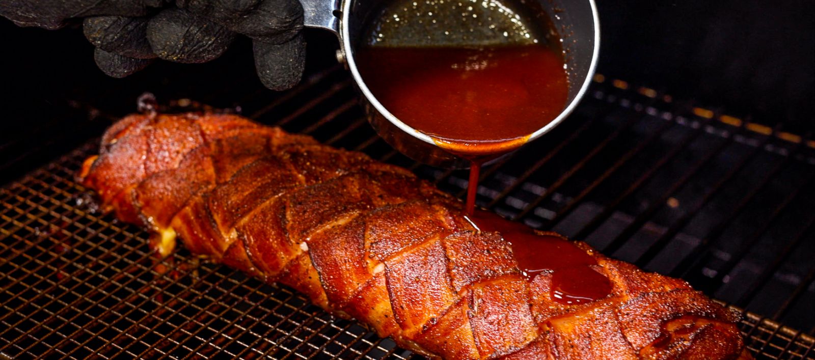 This image shows a bacon chicken fatty drizzled with glaze