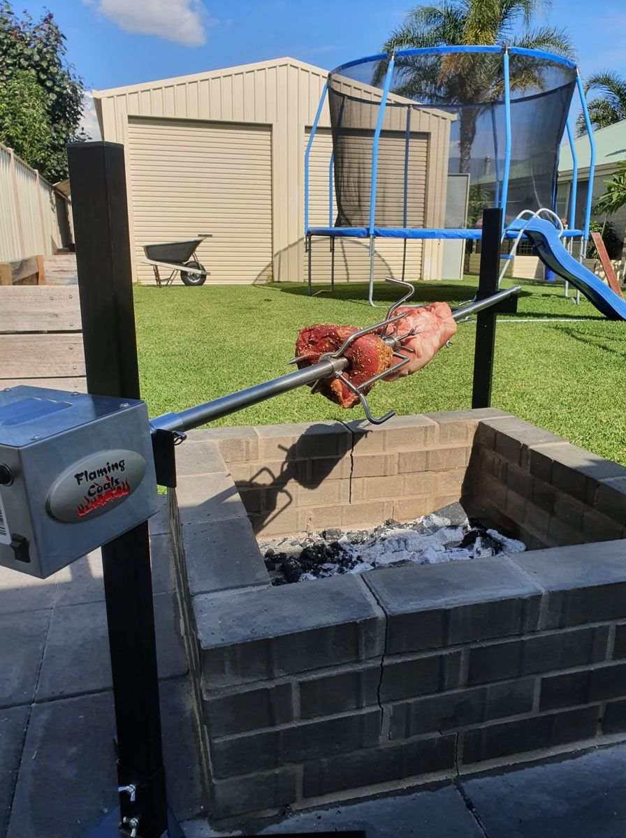 This image show the portable camping spit used to cook roasts over a firepit in the backyard