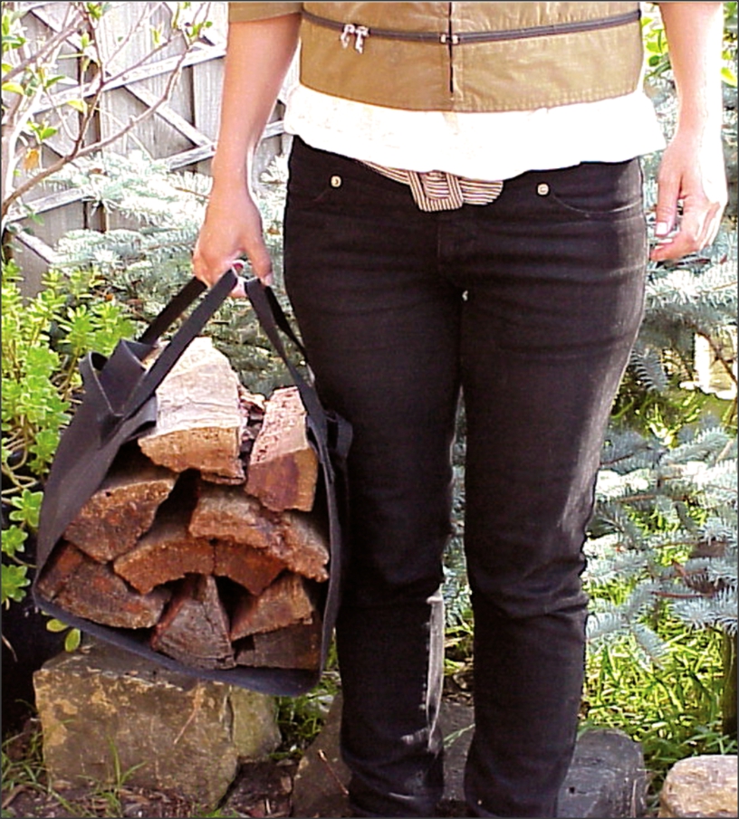 This image shows the firewood carry sling that is sold as part of the fireplace starter pack being used and full of timber