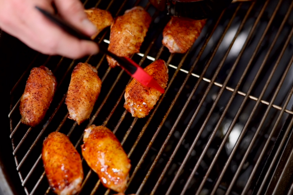 This_image_shows_chicken_wings_being_glazed