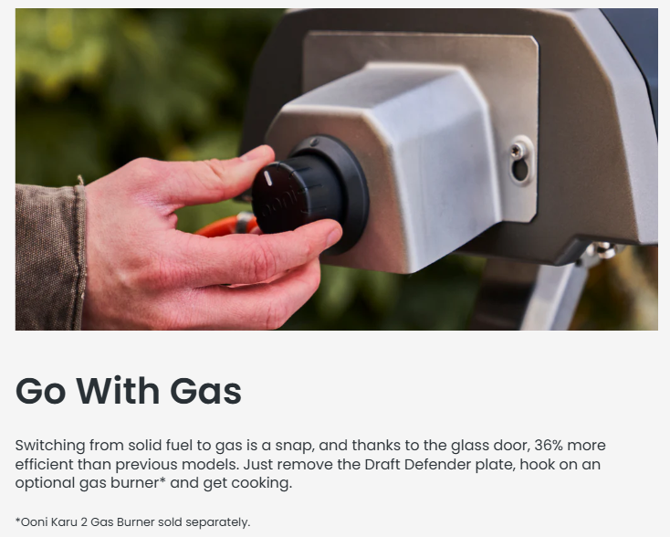 A person adjusts the Ooni Karu 2 Multi-Fuel Pizza Oven’s gas attachment knob, showing the ease of switching from wood or charcoal to gas. The sleek metal gas burner fits securely at the back of the oven for convenient, efficient cooking.