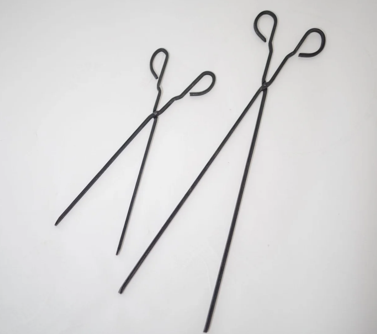 This is an image that shows the 2 different length Fireplace tongs available to buy in Australia