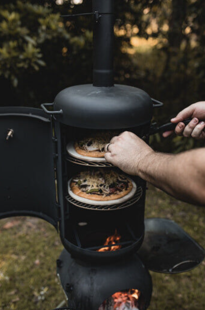 The Ozpig Oven Smoker lit with food being placed inside