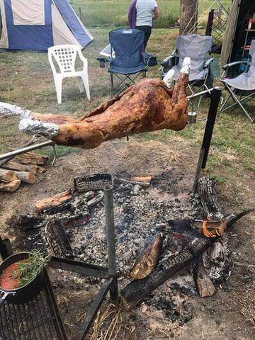 This image shows lamb being cooked on Portable Camping Spit