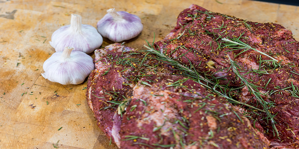 This image shows a lamb with rosemary and garlic