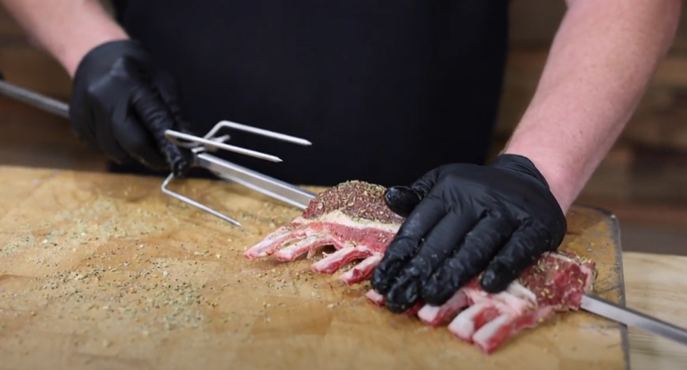 This_image_shows_lamb_rack_being_put_on_the_skewer