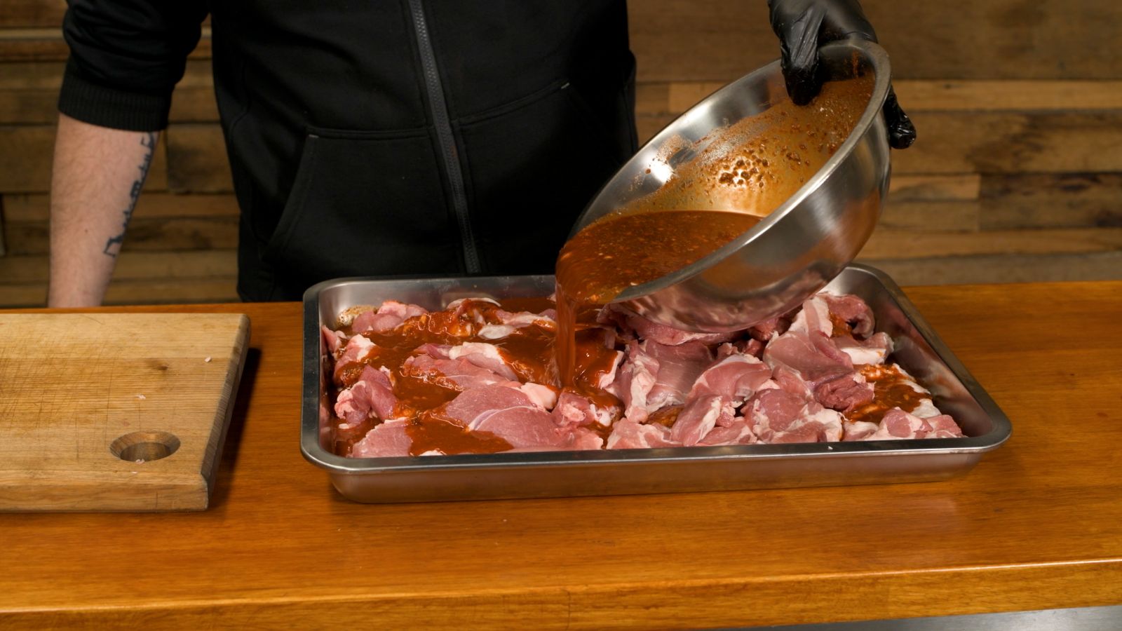 Marinating sliced pork with a rich Al Pastor marinade made from pineapple juice, achiote paste, chipotle, and spices before refrigerating for maximum flavour.