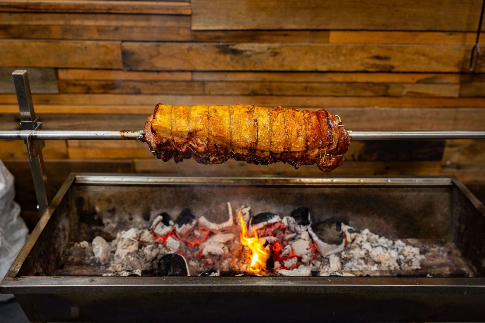 This_image_shows_porchetta_being_cooked_on_Spit_rotisserie