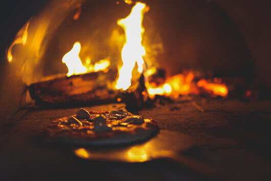 This_image_shows_cooking_in_a_wood_fired_pizza_oven