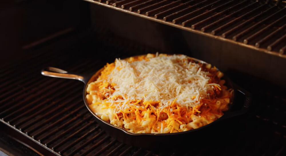 This image shows the mac and cheese mixture being placed in the smoker