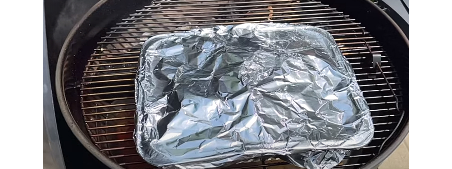This image shows a pork belly brisket on aluminum pan