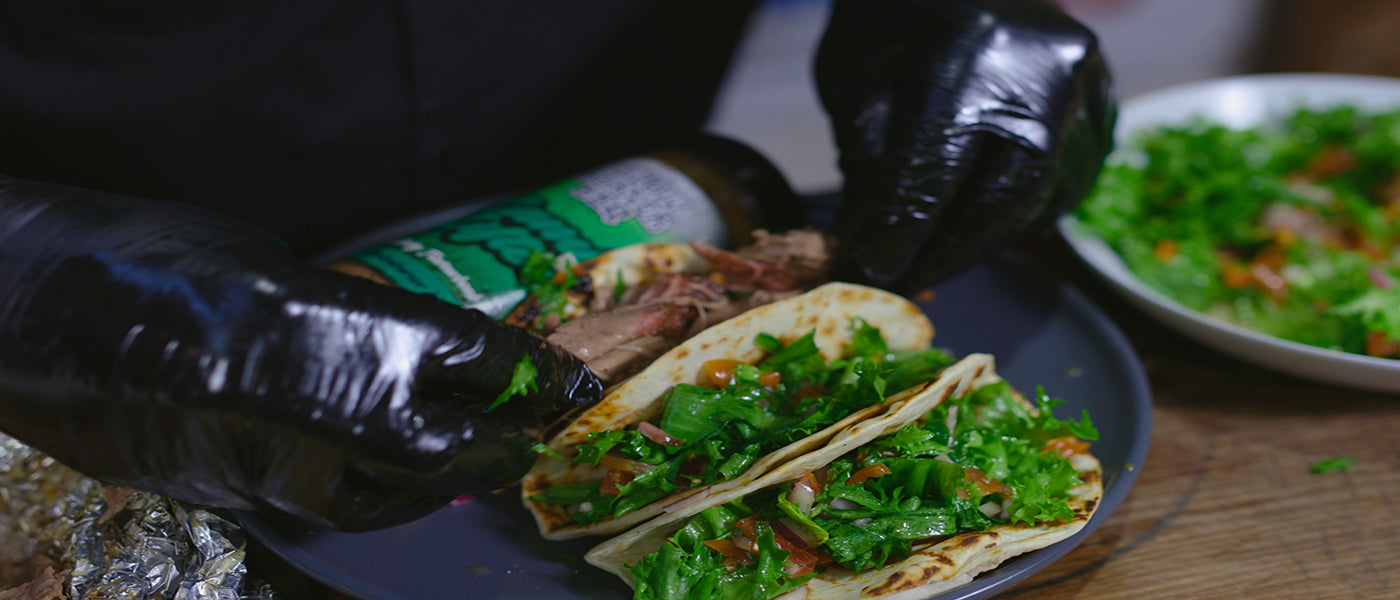 This image shows pulled lamb and fresh salad added to tortilla