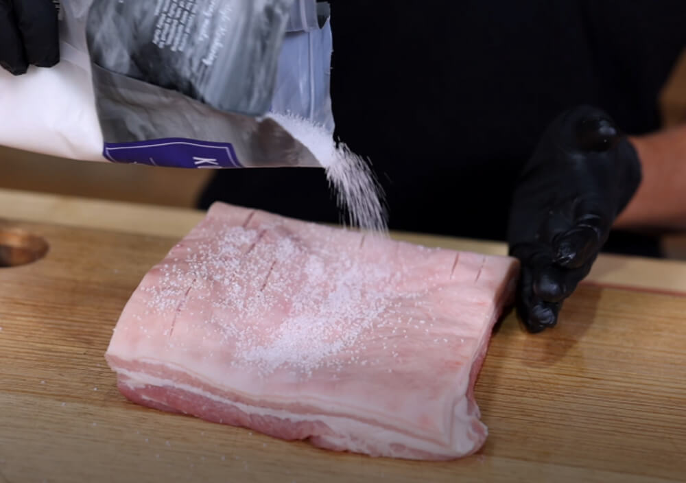 This_image_shows_pork_belly_being_salt