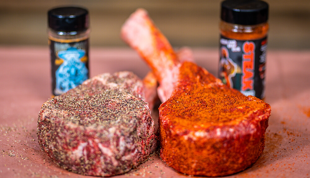 This image shows Tomahawk Steak being seasoned with Low N Slow Steak Shooter and Boomas BBQ Grazed and Blazed. 