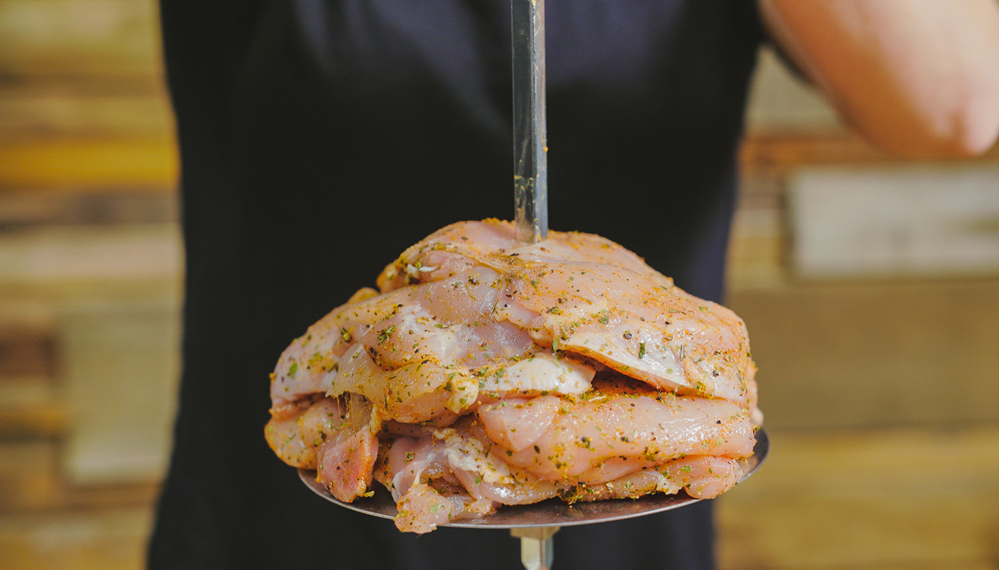 This image shows chicken thighs placed on the skewer