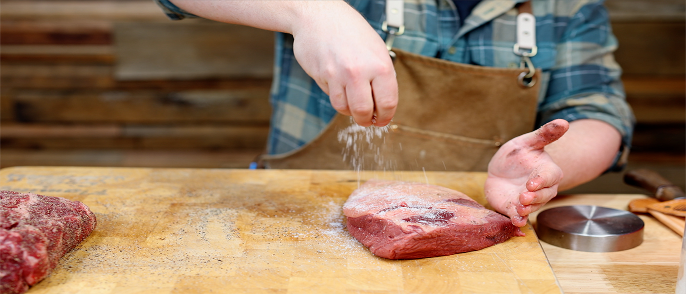 This image shows Tom seasoning the Rump cap with salt