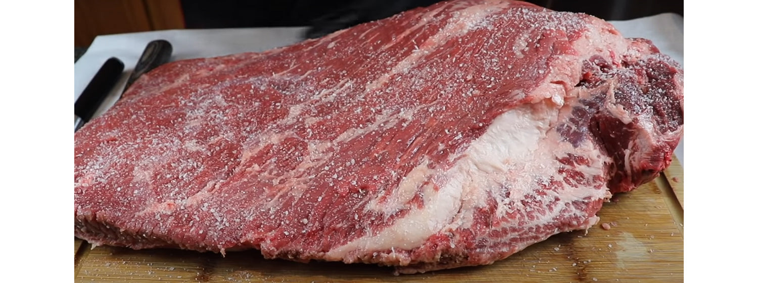 This image shows a brisket seasoned with salt.