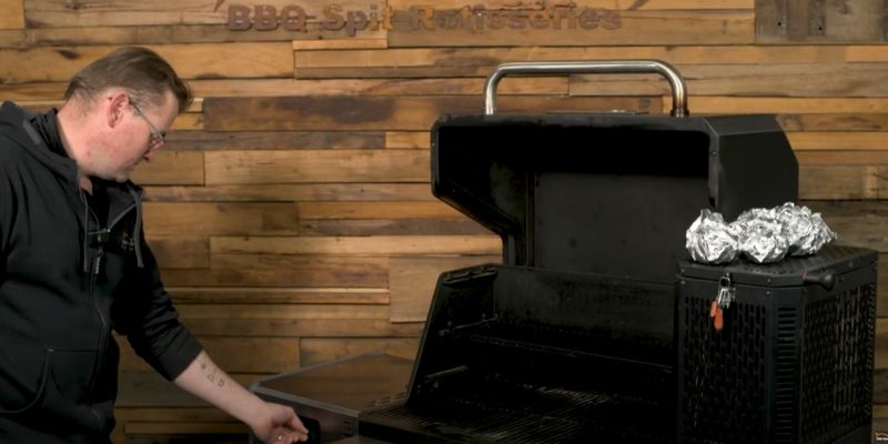 etting up a Masterbuilt Gravity Feed Smoker to 360°F for grilling and smoking with foil-wrapped food on the side hopper.