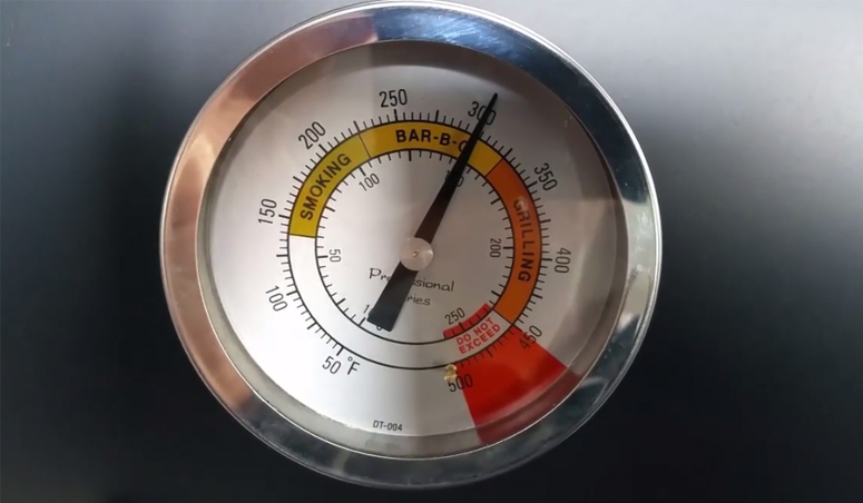 This picture shows the smoker temperature gauge at 150c during the offset smoker seasoning process