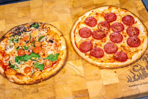 This image shows two pizzas cooked on pizza oven