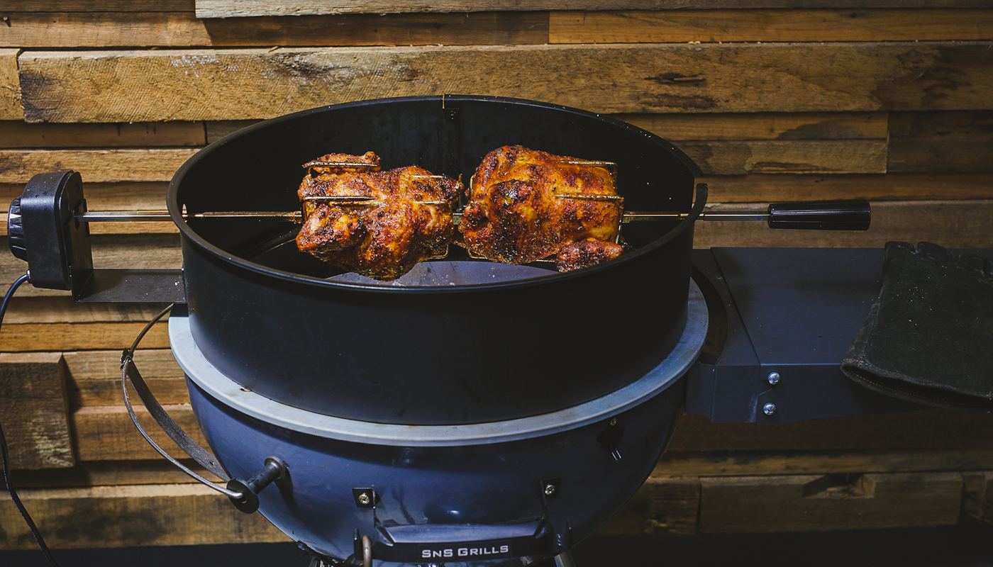 This image shows two chickens cooked on SNS Kettle BBQ