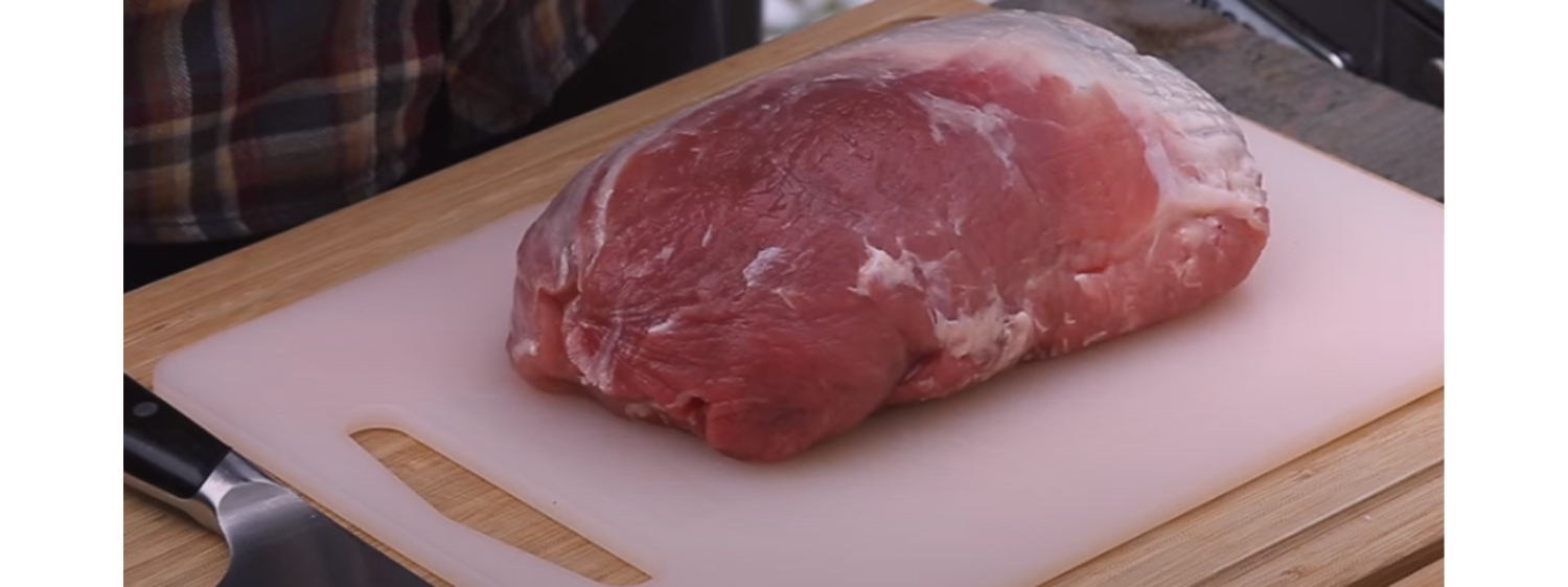 This image shows a whole pork loin before in is prepared for cooking